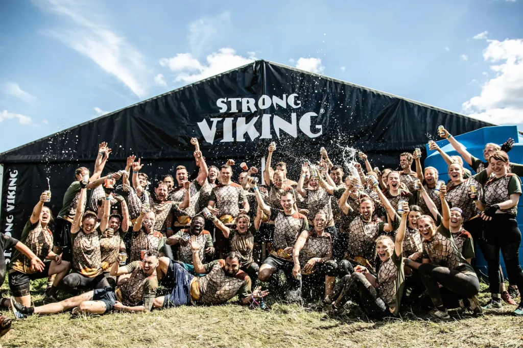 A group of colleagues cheering and toasting in a photo during strong viking
